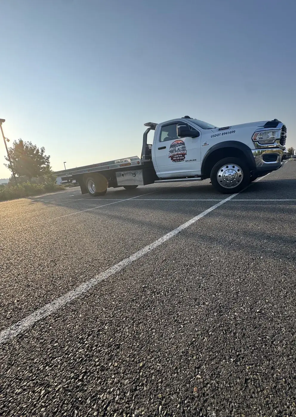 Low-angle view of Pathfinder Towing's rollback flatbed truck